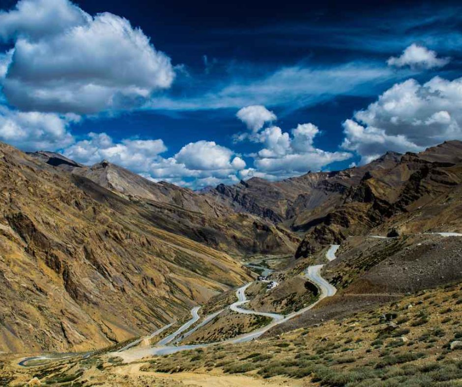 Scenic view of the Karakoram road winding through majestic mountains, showcasing nature's beauty and adventure.